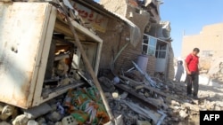 A man walks on the rubble of a mosque following an explosion near Baghdad amid an upsurge in violence. (file photo)