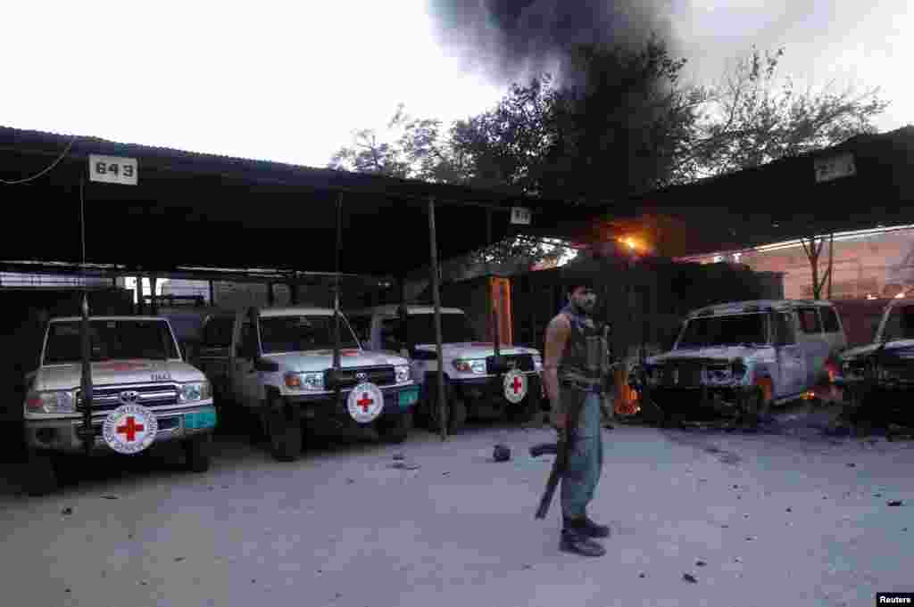 An Afghan policeman keeps watch at the Red Cross compound in Jalalabad Province, which was attacked by two suicide bombers on May 29. Besides both assailants, one guard was also killed in the incident. (Reuters/Parwiz)