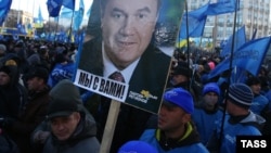 "We are with you" says the sign under the photograph of Ukrainian President Viktor Yanukovych at a pro-government rally in Kyiv on December 14.