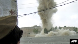 A tribesman watches a strike on an alleged militant hideout in Miranshah (file photo)