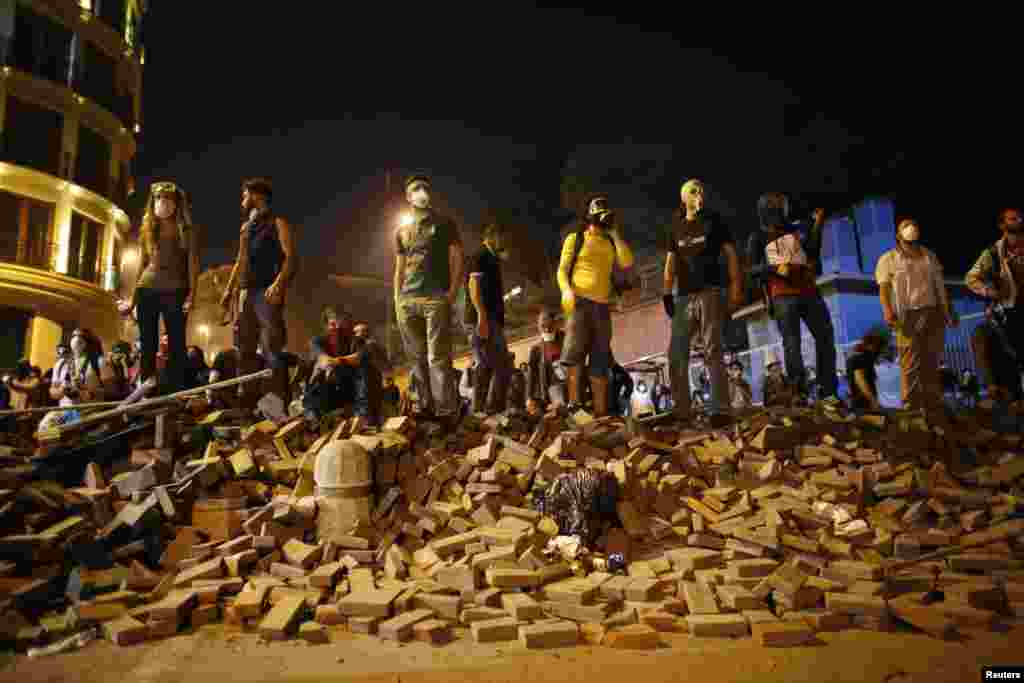 Antigovernment protesters stand on a barricade during a demonstration in Istanbul on June 4.