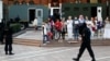 Belarus - Women attend an opposition demonstration to protest against presidential election results as law enforcement vehicles are seen in the background, in front of the Church of Saints Simon and Helena at the Independence Square in Minsk, 28aug2020