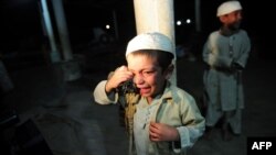 Pakistan -- A young student cries after being rescued following a police raid on Madrassa Zakarya in Karachi, 12Dec2011