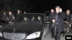 Security guards flank the Polish and Georgian leaders during their visit to the South Ossetia border area