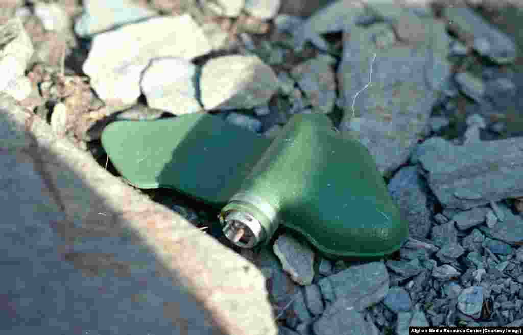 A "butterfly mine" lying in wait for a victim. Millions of the cellphone-sized devices were dropped from Soviet aircraft across Afghanistan. The jungle-colored mines were easily spotted and avoided by fighters, but many injured curious children.