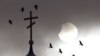 Birds fly past an Orthodox church during a partial solar eclipse in the town of Volozhin, Belarus, on January 4. (Reuters/Vasily Fedosenko)