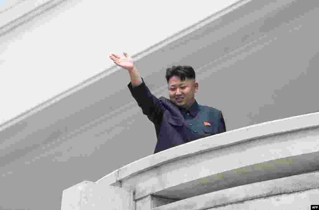 North Korean leader Kim Jong Un waves to the crowd.