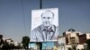 FILE PHOTO - An Iranian man walks past an electoral portrait of presidential candidate Mohammad Baqer Qalibaf in Tehran, May 15, 2017