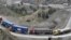 Trucks drive through the mountainous area near Torkham by Afghanistan's border with Pakistan. (file photo)