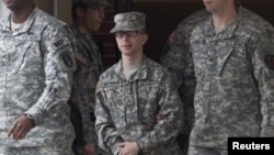 U.S. Army Pfc. Bradley Manning (center) is escorted by military police from the courthouse after a hearing at Fort Meade, Maryland, in December.