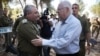Israeli President Reuven Rivlin (R) is greeted by Israeli chief of Staff Gadi Eizenkot as he visits near the Israel-Gaza border area on August 23, 2016 (Photo by MENAHEM KAHANA / AFP)
