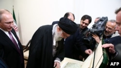 Iranian Supreme Leader Ayatollah Ali Khamenei (center) receives a copy of an ancient manuscript of the Koran from Russian President Vladimir Putin (left) during their November 23 meeting in Tehran.