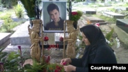 Mahboobeh Ramezani is seen at her son's grave in an undated photo.