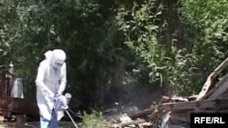 A worker in southern Kazakhstan sprays pesticide to kill ticks, the carriers of hemorrhagic fever.