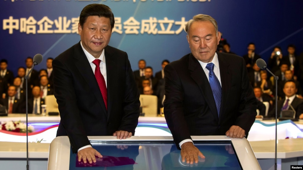 China's Xi Jinping (left) and Kazakhstan's Nursultan Nazarbaev put their palms on a screen during a gas-pipeline-launching ceremony in Astana in September 2013.