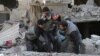 Emergency workers rescue a child following a reported regime air strike in the rebel-held Syrian town of Hamouria in the besieged Eastern Ghouta region on February 21.