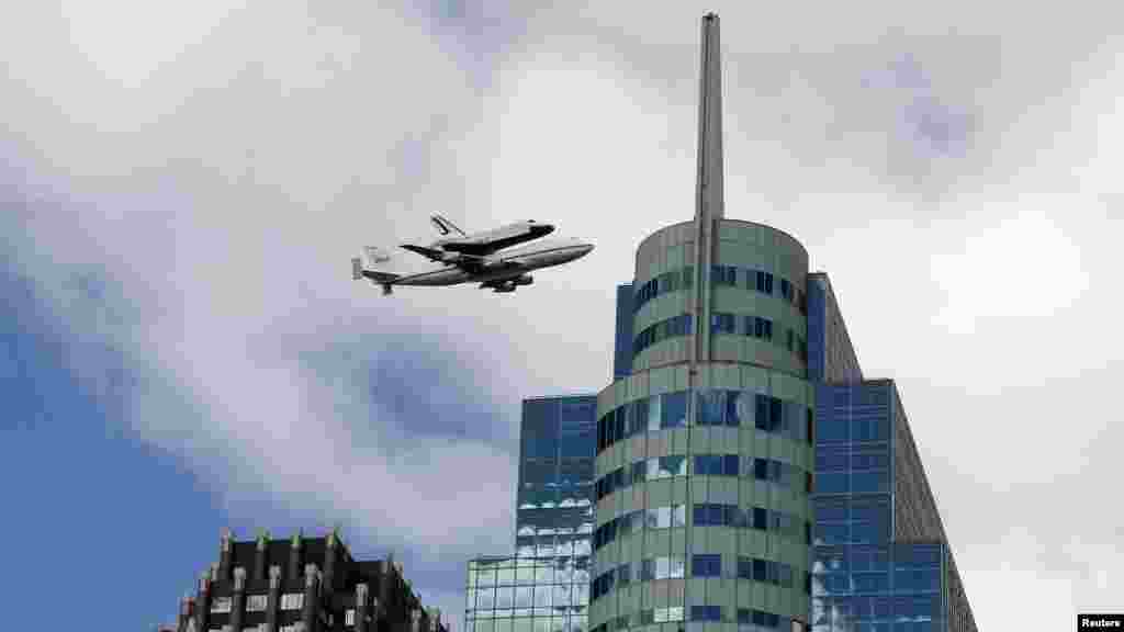 U.S. -- The Space Shuttle Enterprise rides atop a NASA modified 747 plane as it flies over Jersey City, 27Apr2012