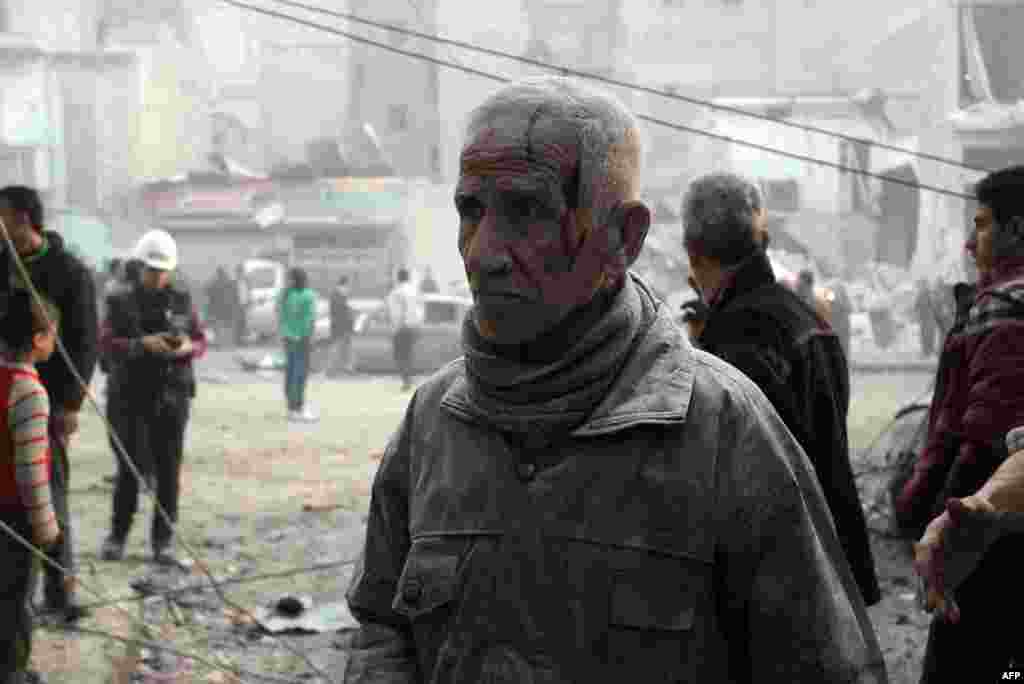 A man, injured and covered in dust, stands in a street of the northern city of Aleppo after an alleged air strike by Syrian government forces on January 29. (Topshots/AFP/Momammed Al-Khatieb)