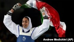 Iran's Kimia Alizadeh celebrates after winning the bronze medal in women's taekwondo at the 2016 Summer Olympics in Rio de Janeiro.