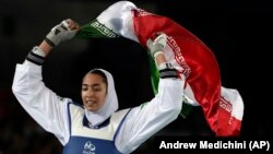 Kimia Alizadeh of Iran celebrates after winning the bronze medal in women's taekwondo at the 2016 Summer Olympics in Rio de Janeiro.