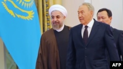 Kazakh President Nursultan Nazarbaev (right) welcomes visiting Iranian President Hassan Rohani in Astana on September 9.