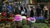 In this Monday, March 19, 2018 photo, Iranians shop for hyacinths, garlic, sprouts and other items used to celebrate the Iranian New Year, at the Tajrish traditional bazaar in northern Tehran.