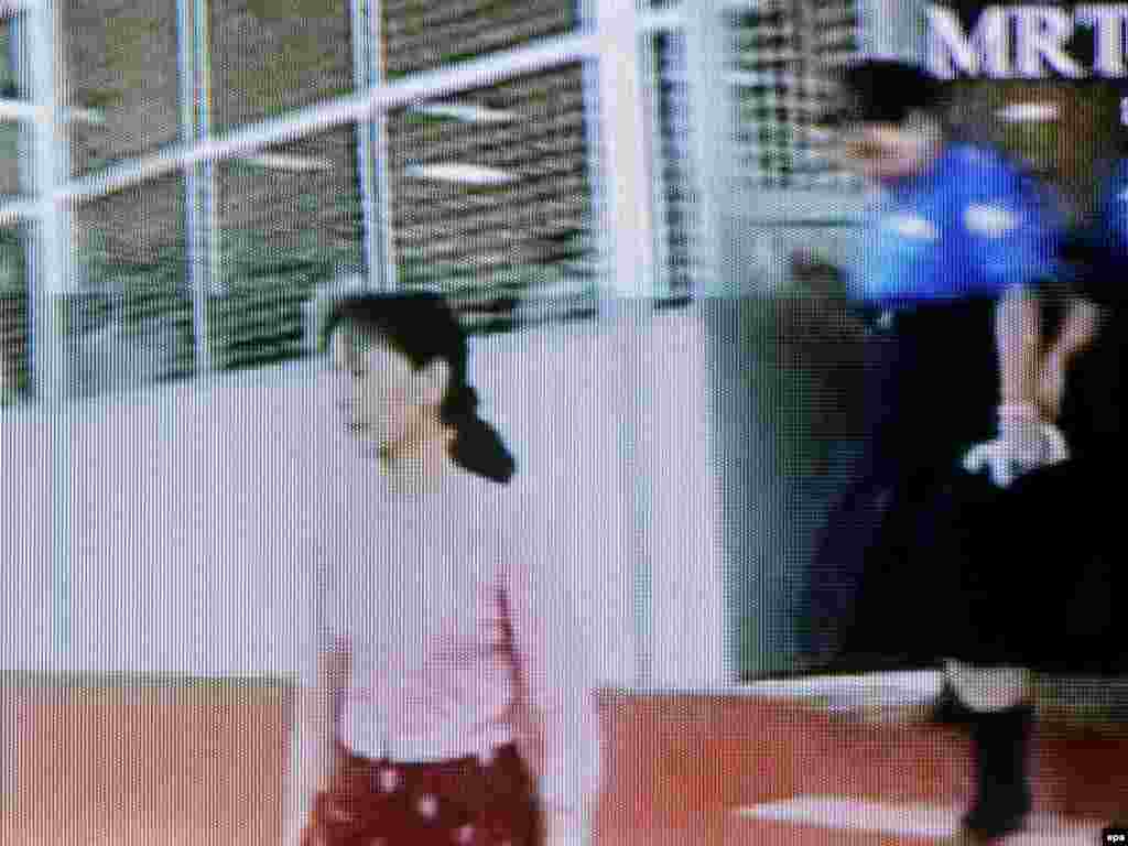 Myanmar -- A TV grab shows Aung San Suu Kyi at Insein Prison, Yangon, 20May2009 - Caption: epa01737431 A TV grab taken from Thai television TV3 broadcast Myanmar MRTV video footage showing Myanmar democracy icon Aung San Suu Kyi (L) accompanied by Myanmar female prison officials inside Insein Prison, Yangon, Myanmar, 20 May 2009. Diplomats and journalists were not invited to the fourth day of democracy icon Aung San Suu Kyi's trial after the junta allowed them to attend proceedings a day earlier. Suu Kyi, 63, is the leader of the National League for Democracy opposition party, which won the 1990 general election by a landslide but has been blocked from power by Myanmar's junta for the past 19 years. Suu Kyi has spent 13 of those years under house arrest.