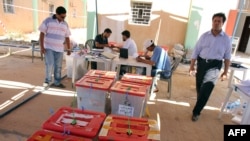 Libyan High Election Commission workers set ballot boxes from different polling stations as they prepare for the final counting in Benghazi on July 8.