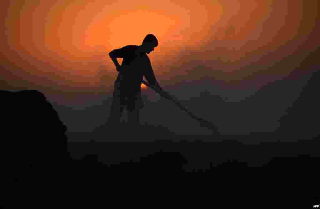 An Afghan laborer works in a chalk factory at sunset on the outskirts of Mazar-e Sharif. (AFP/Farshad Usyan)