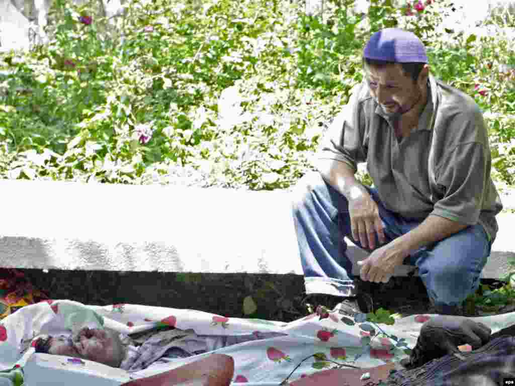 An ethnic Uzbek man looks at the bodies of victims of clashes between the Kyrgyz and Uzbek communities in Osh.