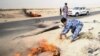IRAQ - Iraqi policemen threw sand to put out tyres that the protesters had set ablaze during a protest at the main entrance to the giant Zubair oilfield near Basra, Iraq July 17, 2018.