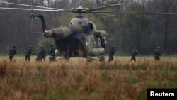 Serbian soldiers disembark from MI-8 helicopter during a joint Serbian-Russian Slavic Brotherhood exercise in the town of Kovin, near Belgrade, in November 2016.