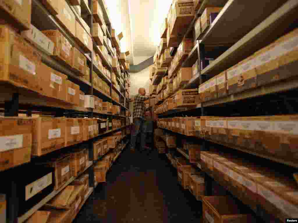 Boxes full of audio-visual recordings are stored on shelves.