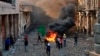 Anti-government protesters start a fire while security forces close Rasheed Street during clashes in Baghdad on November 28.