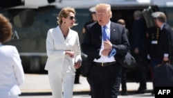 U.S. President Donald Trump (left), with Ambassador to Canada Kelly Craft, walks to Air Force One prior to departure from Canadian Forces Base Bagotville in Canada in June 2018.
