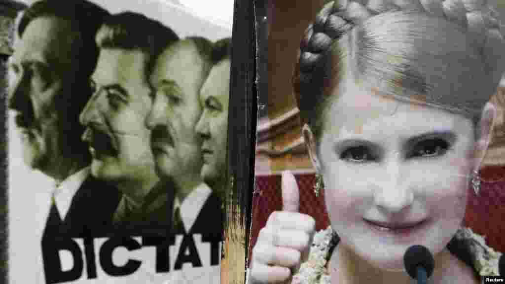 A portrait of Tymoshenko is placed in front of the portraits of Hitler, Stalin, Belarus&#39;s Alyaksandr Lukashenka, and President Viktor Yanukovych in a camp of Tymoshenko supporters in Kyiv.