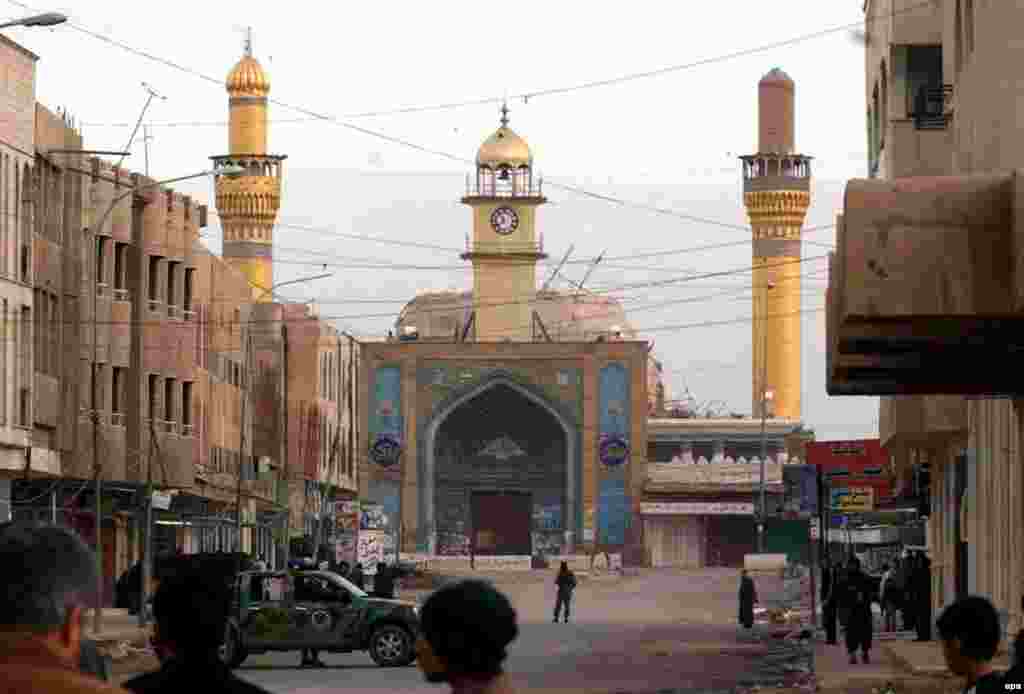 Security forces guard the mosque following the February 2006 bombing that destroyed the golden dome (epa) - A second shrine marks the place where the hidden -- or 12th -- imam, al-Mahdi, son of Hasan, went into hiding.