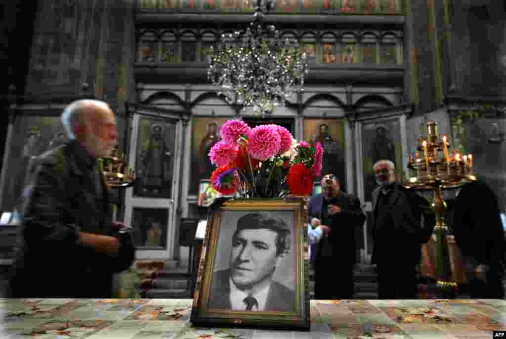 People attend a commemoration service in honor of Georgi Markov, a Bulgarian dissident killed in London in 1978 by suspected Soviet agents. A statue was erected in Sofia in Markov's honor on November 11. (AFP/Nikolay Doychinov)