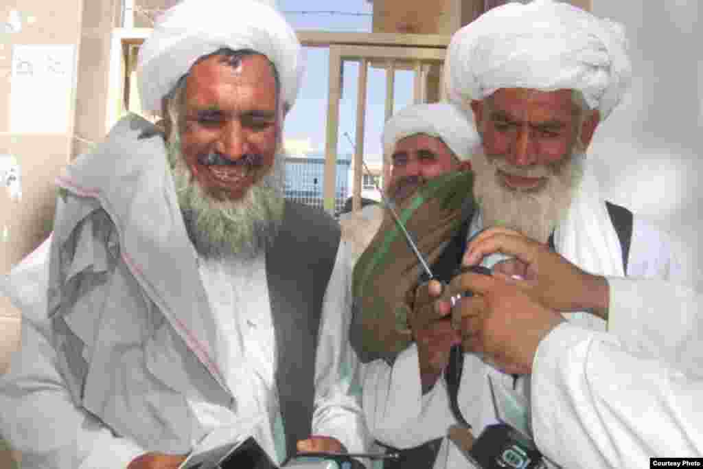 The radios were distributed all across the country. Here 2 village elders in Shindand province...