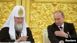 The four were arrested in February 2012 while investigating the construction of summer houses in the region allegedly belonging to President Vladimir Putin (right) and Russian Orthodox Patriarch Kirill.