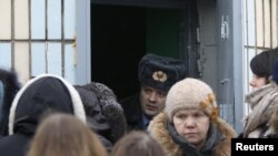 Relatives and friends of opposition activists detained in the protests after the elections wait outside a detention centre in Minsk.