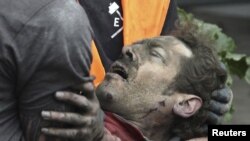 A man is pulled from the rubble in Christchurch.