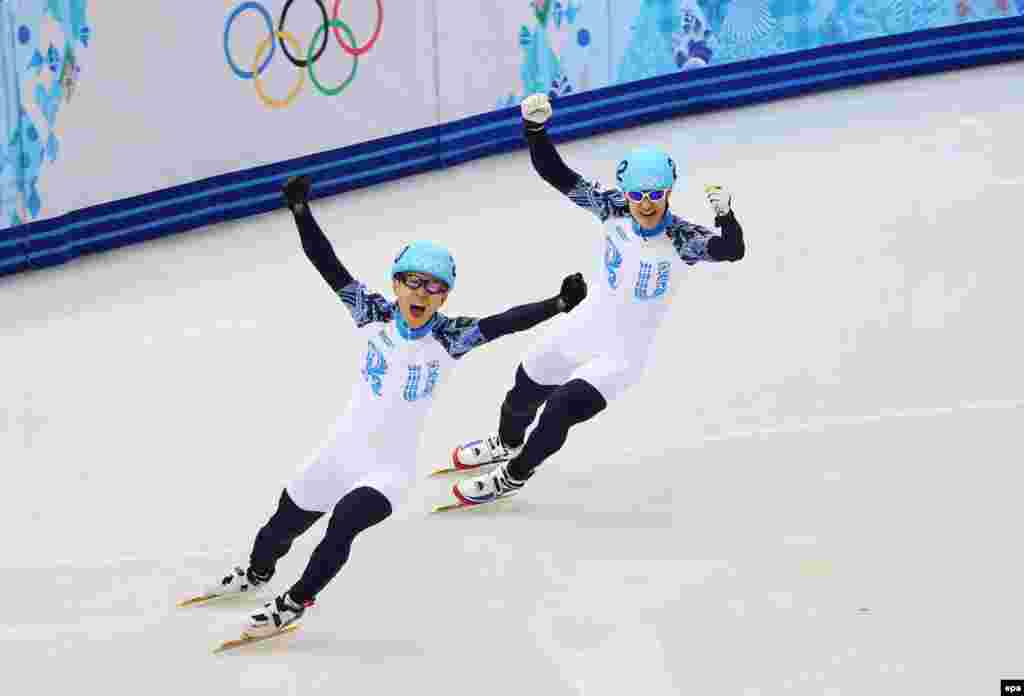 Russia&#39;s Victor An and Vladimir Grigorev celebrate after placing first and second respectively in men&#39;s 1000m at the short track events. (EPA/Hannibal Hanshke)
