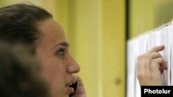 Armenia -- A young woman checking the list of victims at Zvartnots airport in Yerevan, 15 July 2009