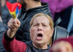 People take part in a rally to support Sandu's government in front of the parliament building in Chisinau on November 12.