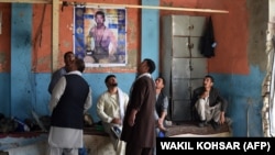 Afghan wrestlers gather at the site of a suicide attack on the morning after a blast targeted wrestlers during a training session at the Maiwand Club in Kabul on September 6.