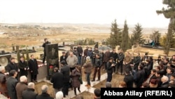 Journalists, politicians, and admirers visit the grave on March 2 of Elmar Huseynov, who was killed in 2005 in Baku.