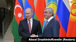 RUSSIA -- Russian President Vladimir Putin (L) shakes hands with his Armenian counterpart Serzh Sargsyan before a meeting of heads of the Commonwealth of Independent States (CIS) outside Moscow, Russia December 26, 2017