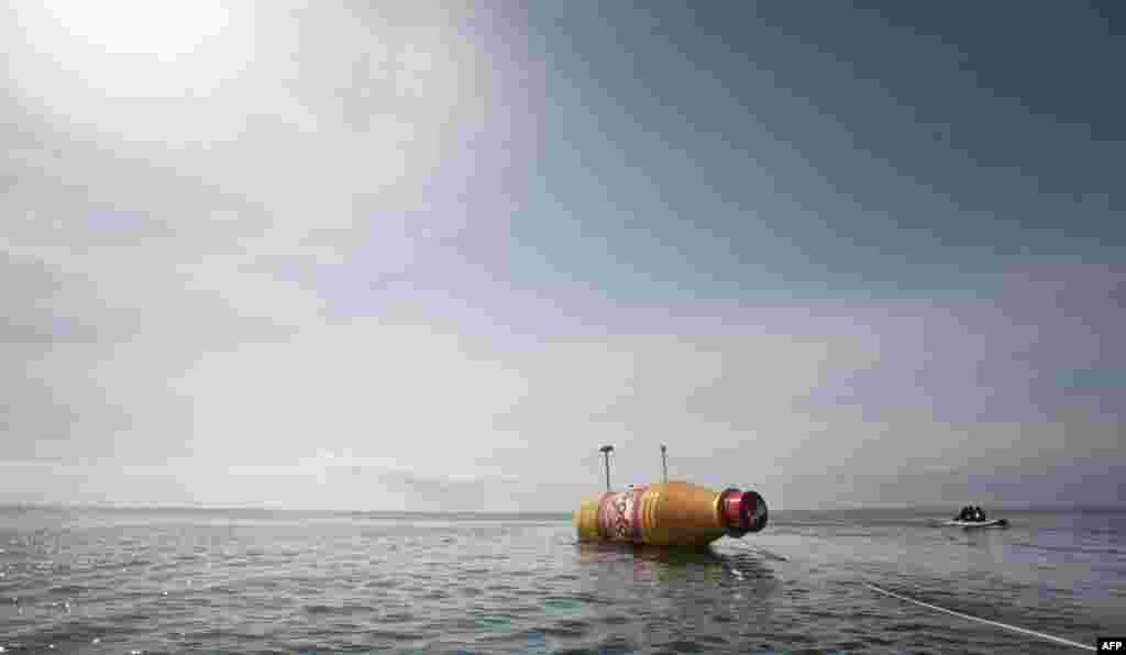 The world&#39;s largest message-in-a-bottle is released into the ocean in Tenerife, Spain, in a project sponsored by the Norwegian soft drink Solo. The 8-meter-long bottle contains a 12-square-meter letter and is equipped with navigation lights required for a drifting object in international waters, solar panels, satellite communications, tracking technology, and a custom camera. (AFP/Desiree Martin)