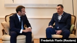 French President Emmanuel Macron (left) speaks with Oleg Sentsov at the Council of Europe in Strasbourg.